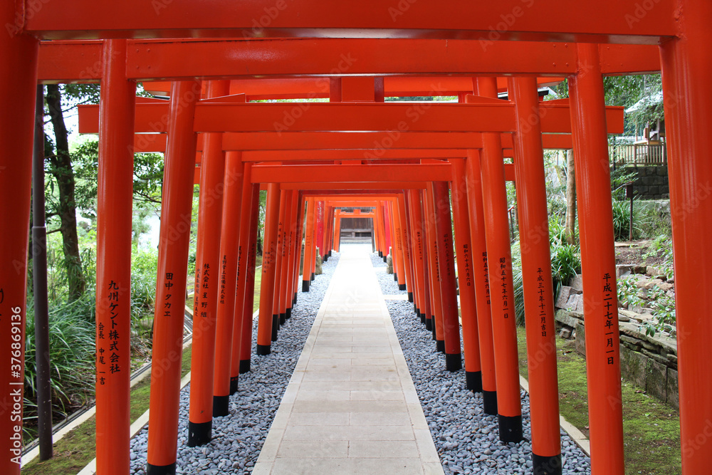 Line of orange torii gates at inari jinja of at Suwa Shrine in Nagasaki.