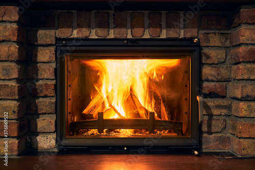 fireplace and fire close view as object or background  brick wall
