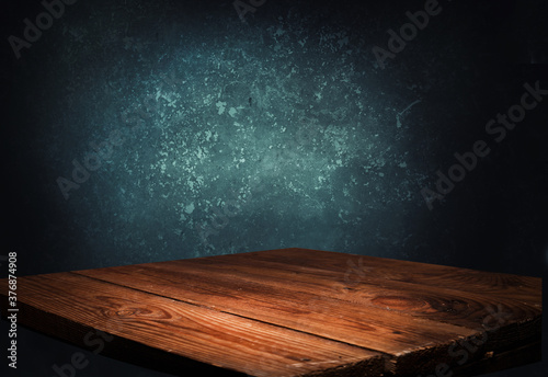 Old wooden table top with smoke on a dark background..