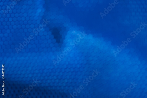 abstract blue binary code blur background with octagon shape bokeh by closeup of deep sea water surface