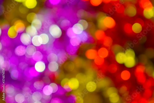 Colorful Christmas background, bokeh effect. Blurry, defocused multicolored lights. The concept of Christmas, New Year. Christmas lights, bright background. Defocused abstract New Year`s background
