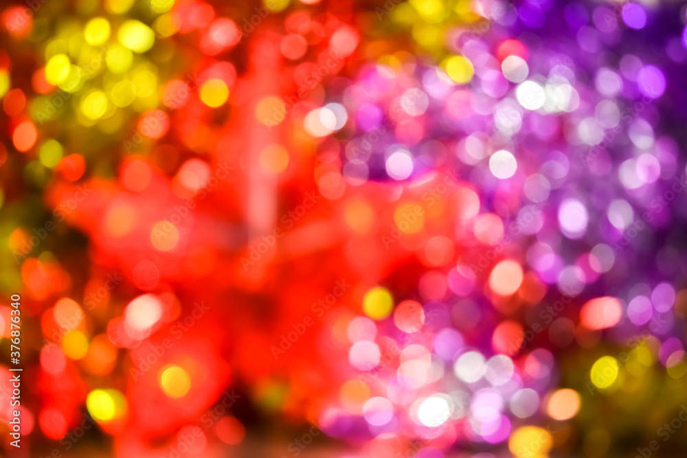Colorful Christmas background, bokeh effect. Blurry, defocused multicolored lights. The concept of Christmas, New Year. Christmas lights, bright background. Defocused abstract New Year`s background