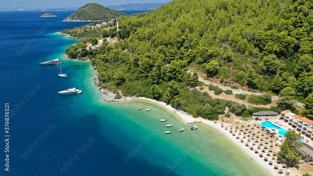 Aerial drone photo of famous crystal clear turquoise beach and bay of Panormos a popular safe sail boat anchorage in island of Skopelos, Sporades, Greece