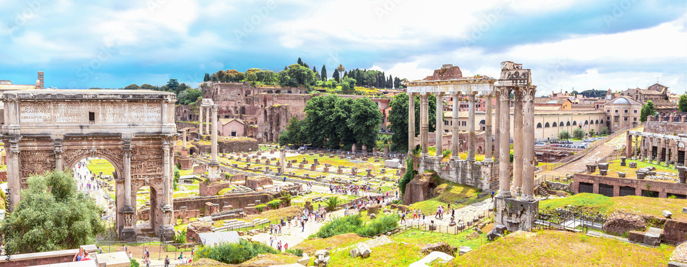 Panoramic view, aerial skyline of  Roman Forum with ancient ruins of temple, columns of Saturn, Triumphal Arch of Septimius Severus, Rome, Italy