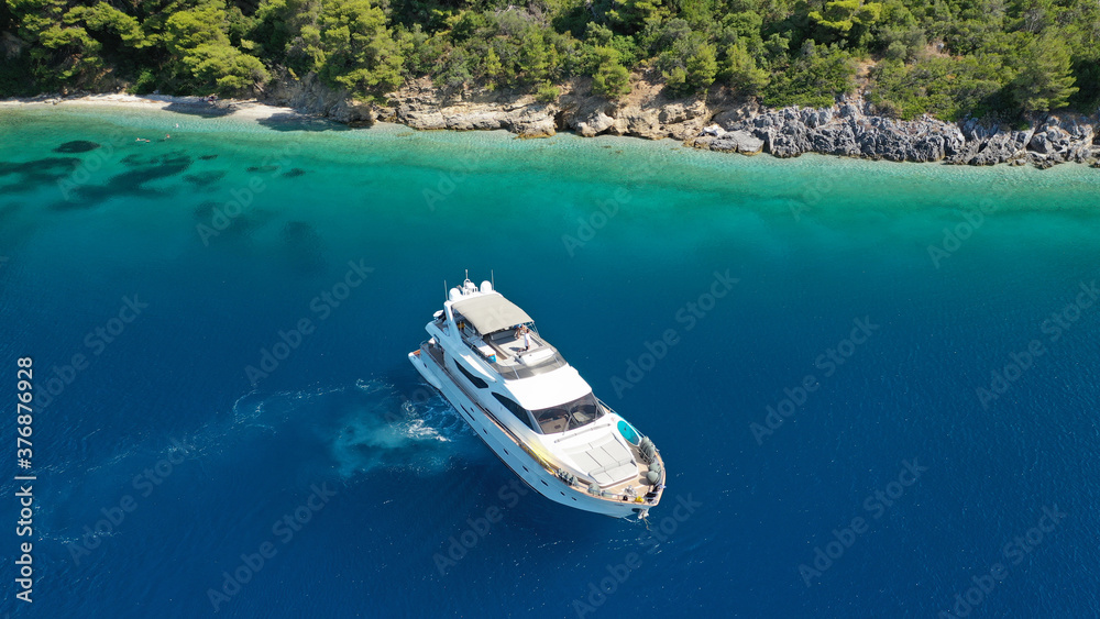 Aerial drone photo of luxury yacht anchored in tropical exotic island bay with turquoise sea