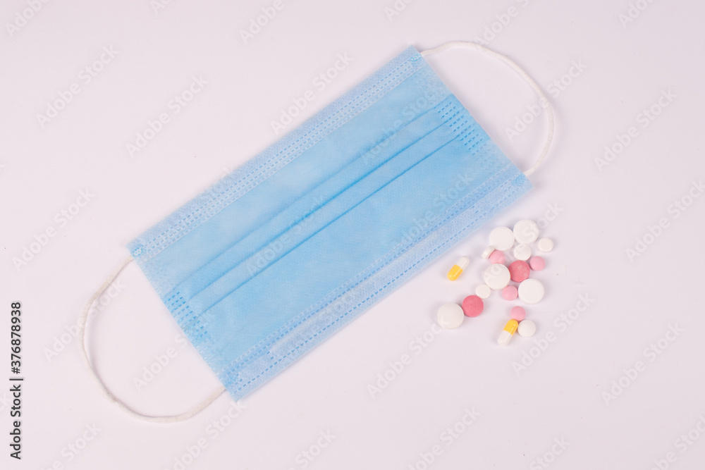 pills and mask on white background pills and mask on white background
