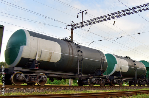 Transport tank car LNG by rail, gas - oil products. LPG transport propane. The fuel train, rolling stock with petrochemical tank cars. Liquefied natural gas export. Soft focus, possible granularity
