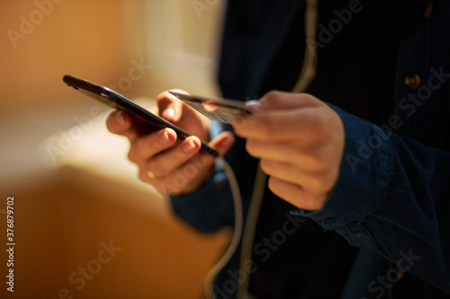 online payments, online purchases. Girl holds a smartphone and a credit card.  photo