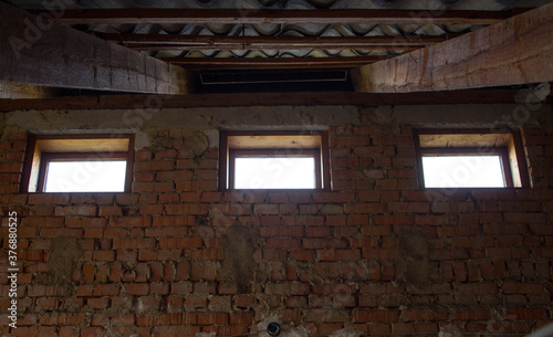 the old brick wall with three windows © ilpo
