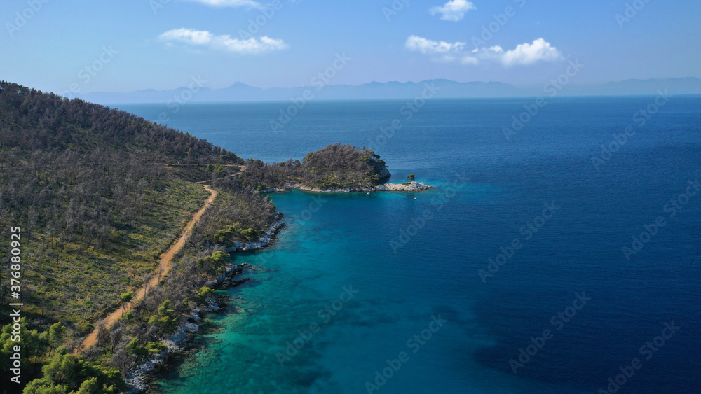Fototapeta premium Aerial drone photo of famous from Mamma Mia movie Three pine cape Amarantos a trully scenic place with crystal clear sea, Skopelos island, Sporades, Greece