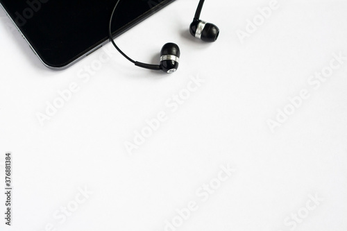 Pad and headphones on a white background, copyspace