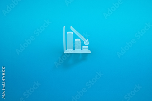 a falling graph in a blue background. a falling arrow. 3D rendering.