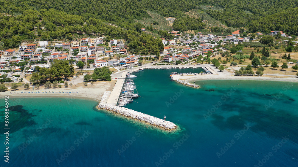 Aerial drone photo of small fishing village of Neo Klima with nearby popular beach of Hovolos, Skopelos island, Sporades, Greece