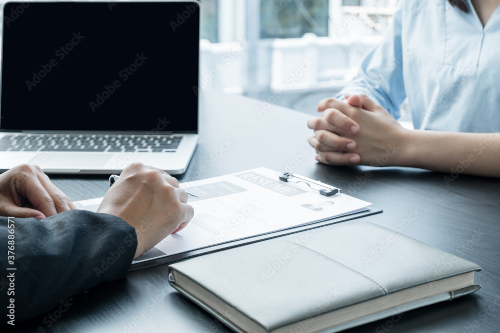 Business people hold a resume and talk to job applicants for job interviews about careers and Her personal history in the company. Recruitment concepts