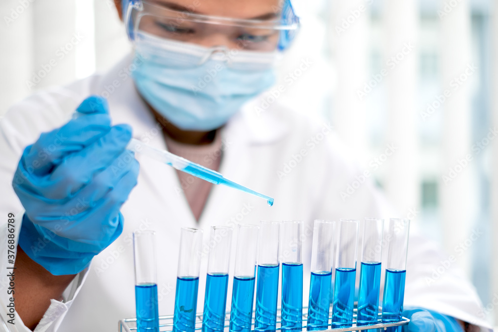 Medical scientists released a sample pipette into a test tube to analyze the virus in a chemical laboratory. Scientific research concepts Medical scientists released a sample pipette into a test tube to analyze the virus in a chemical laboratory. Scientific research concepts