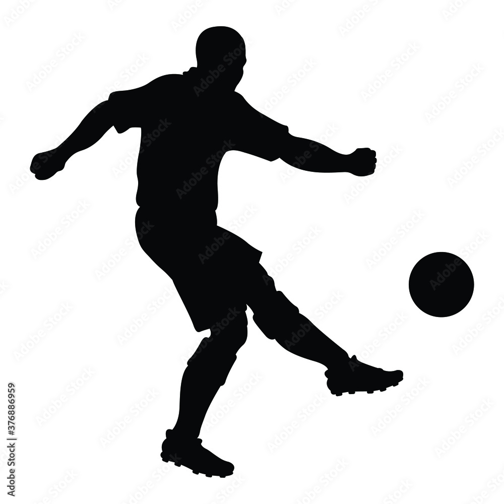 Silhouette of a football player who shooting a ball. 