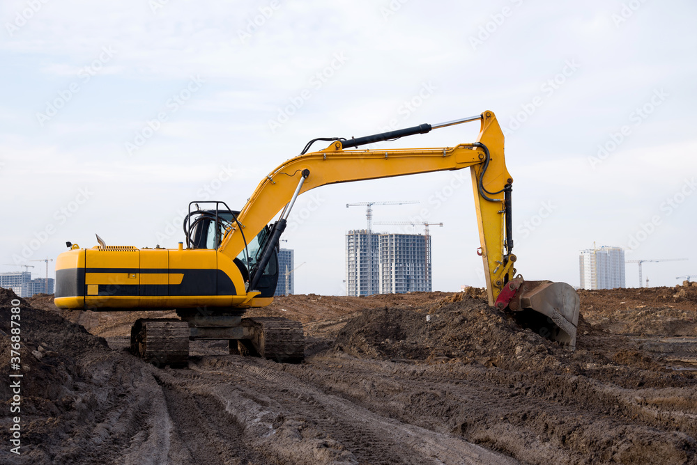Excavator during excavation at construction site. Backhoe on road work. Heavy Construction Equipment Machines for Earthworks. Digger at bridge construction. Excavator during excavation at construction site. Backhoe on road work. Heavy Construction Equipment Machines for Earthworks. Digger at bridge construction.
