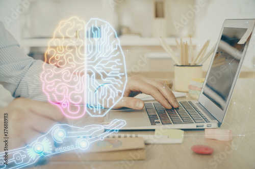 Man typing on keyboard background with brain hologram. Concept of big Data. Double exposure.