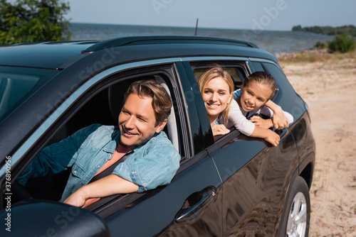 Selective focus of family traveling in car on seaside at daytime © LIGHTFIELD STUDIOS