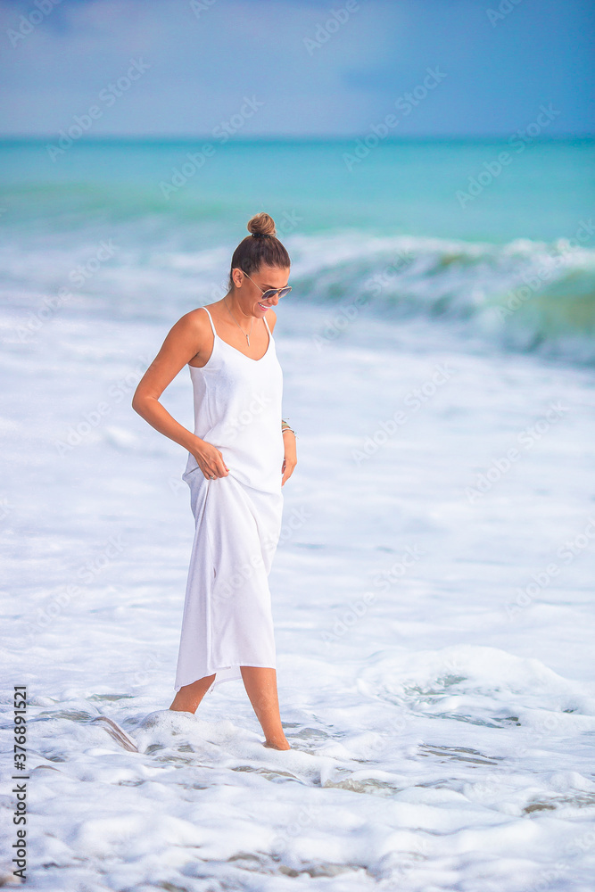 Woman laying on the beach enjoying summer holidays looking at the sea Woman laying on the beach enjoying summer holidays looking at the sea