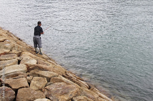 Old Man Fishing at Beach
