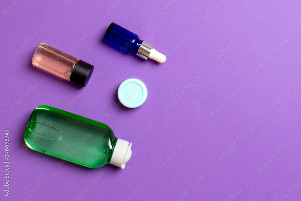 Cosmetics SPA branding mock-up, top view with copy space. set of tubes and jars of cream flat lay on colored background Cosmetics SPA branding mock-up, top view with copy space. set of tubes and jars of cream flat lay on colored background