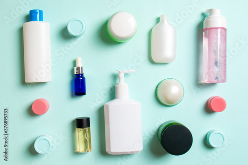 Group of plastic bodycare bottle Flat lay composition with cosmetic products on colored background empty space for you design. Set of White Cosmetic containers, top view with copy space