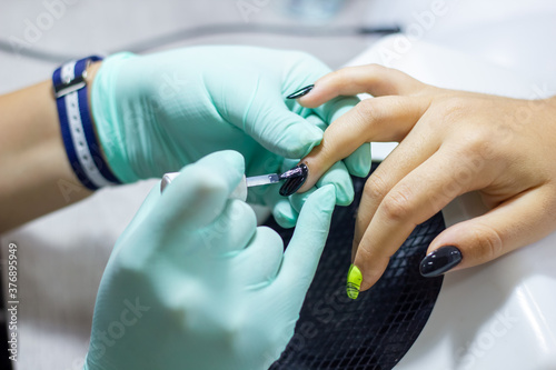 professional manicurist doing nail polish in beauty salon  professional manicurist at work