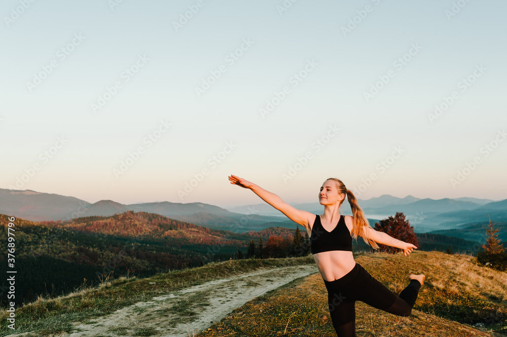 Meditation. Woman balanced, practicing meditation and zen energy yoga in mountains. Girl doing fitness exercise sport outdoors in morning. Healthy lifestyle concept. Sunrise. Side view. Meditation. Woman balanced, practicing meditation and zen energy yoga in mountains. Girl doing fitness exercise sport outdoors in morning. Healthy lifestyle concept. Sunrise. Side view.