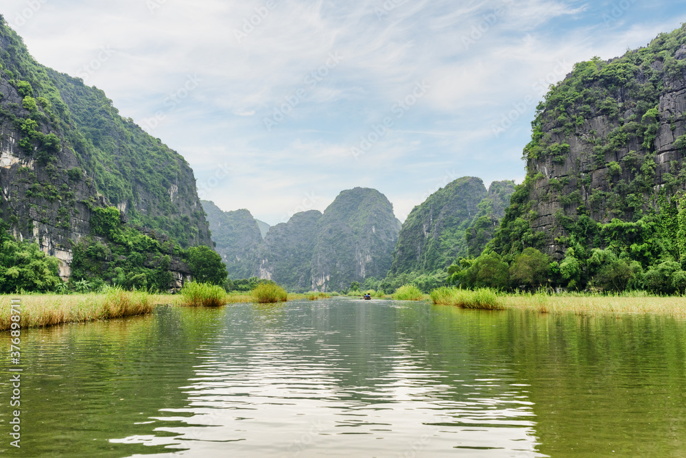 Natural karst towers reflected in the Ngo Dong River, Vietnam Natural karst towers reflected in the Ngo Dong River, Vietnam