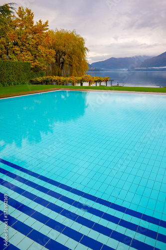 Swimming Pool and Alpine Lake Maggiore with Mountain in Ticino  Switzerland.