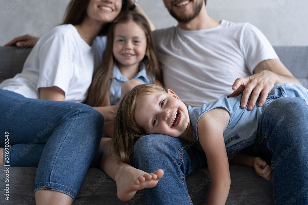 Cheerful family at home sitting in sofa