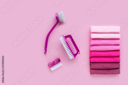 Professional set for general house cleaning. Multi-colored microfiber cleaning towels and purple brushes.