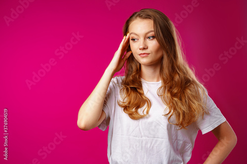 Young beautiful woman suffering from headache with hands on head