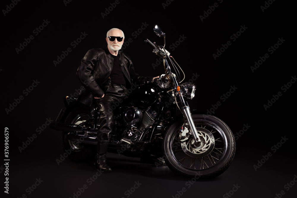 Portrait of his he nice attractive cool content grey-haired guy hipster traveler sitting on chopper having fun weekend vacation holiday tour trip chill isolated black color background Portrait of his he nice attractive cool content grey-haired guy hipster traveler sitting on chopper having fun weekend vacation holiday tour trip chill isolated black color background