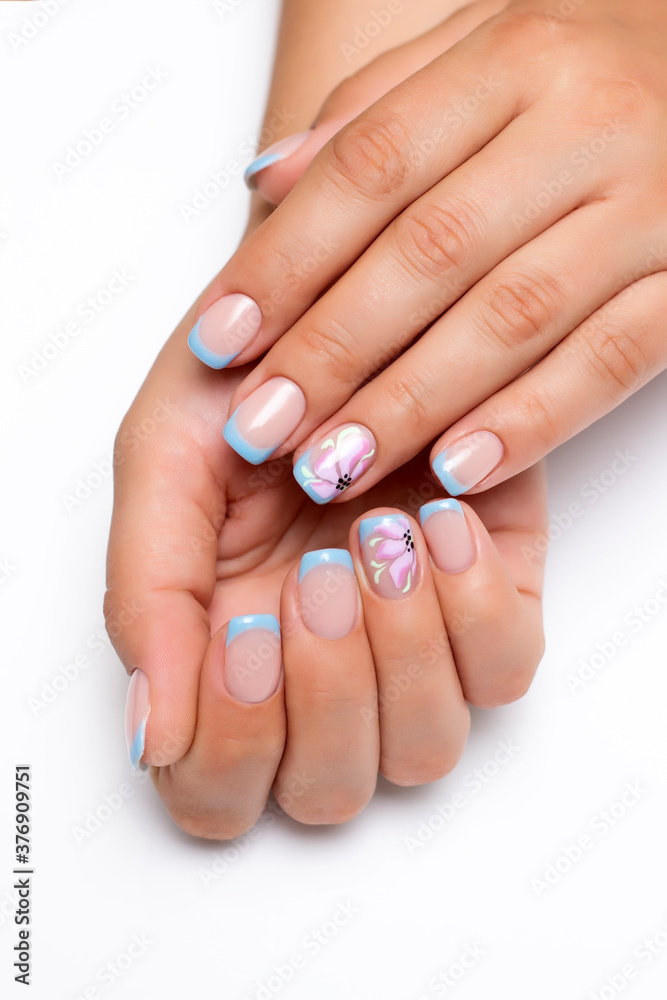 Gel nails. Blue French manicure on short square nails with painted lilac flowers Gel nails. Blue French manicure on short square nails with painted lilac flowers