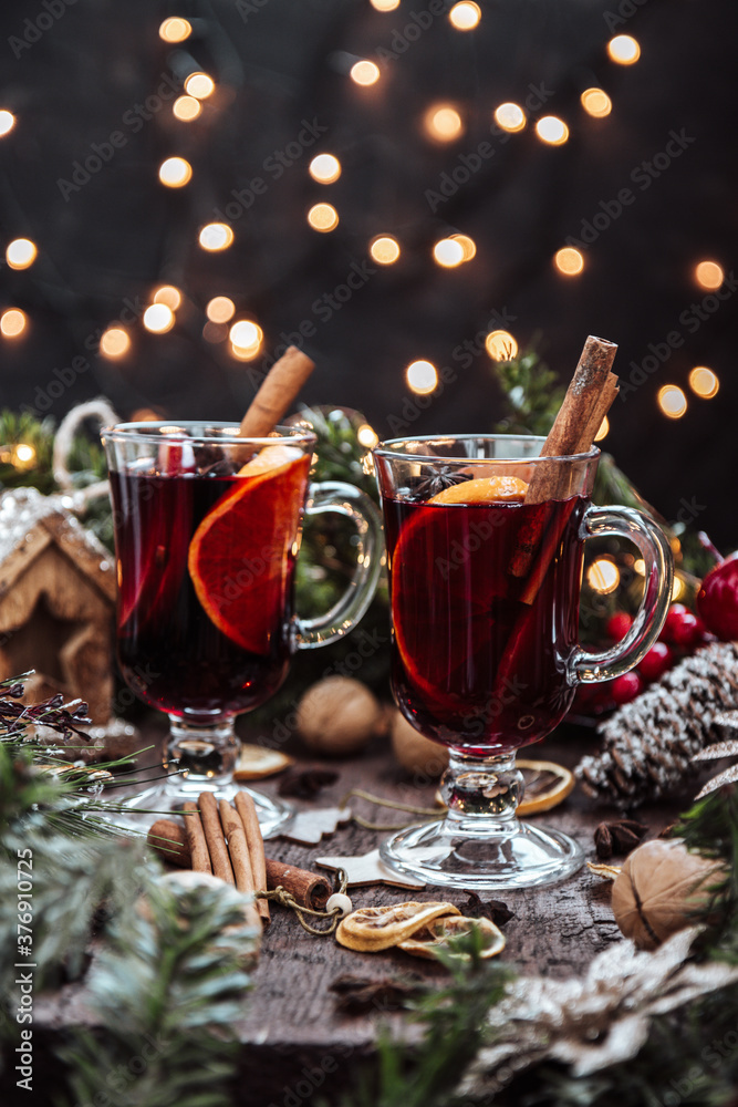 Two glasses of mulled wine in New Year's surroundings, hot wine. Beautiful Christmas background, vertical photo Two glasses of mulled wine in New Year's surroundings, hot wine. Beautiful Christmas background, vertical photo