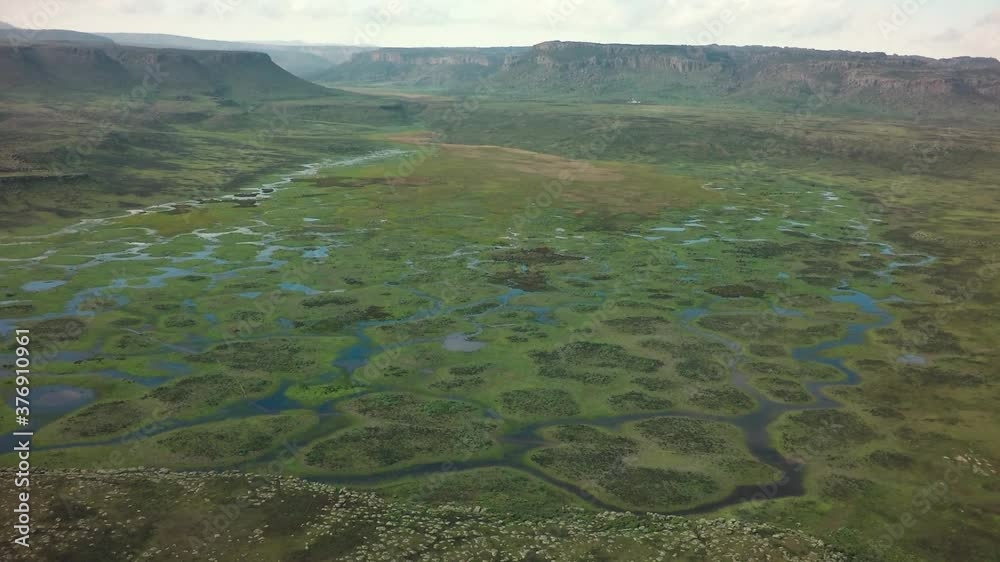 Wetlands flooded landscape with mountains in background, Ethiopia Wetlands flooded landscape with mountains in background, Ethiopia