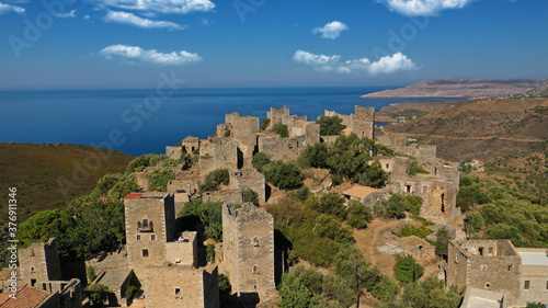 Aerial drone photo of picturesque abandoned old stone tower village of Vatheia overlooking deep blue sea in Mani Peninsula  Peloponnese  Greece