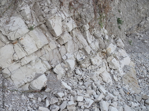 Natural background. Closeup edged shabby cliff cracks. Gray-brown stone rock texture of mountains. Vintage and faded matt style colour in tinted photo. Concept of geolog, mountaineering or hard work. photo