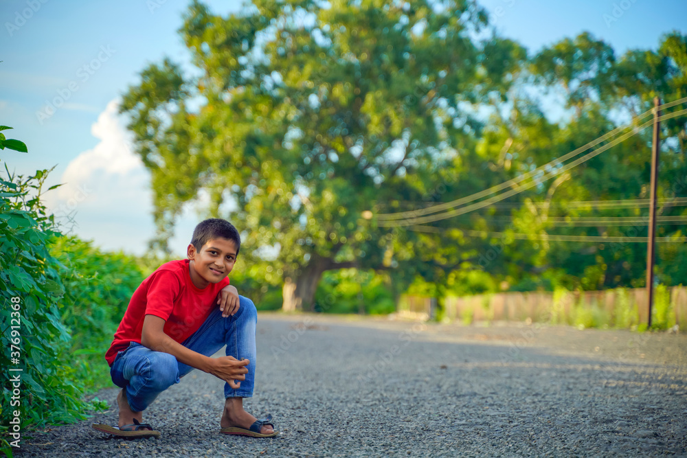 Happy indian child playing at ground