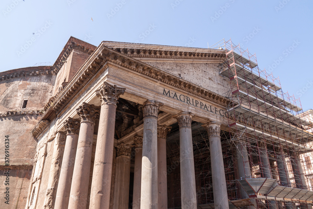 Obraz premium The Pantheon, and Basilica of Santa María Rotonda, partially covered with scaffolding during the rehabilitation works of its main facade.