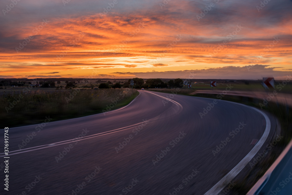 winding asphalt road with added motion blur, good as a base for car rendering