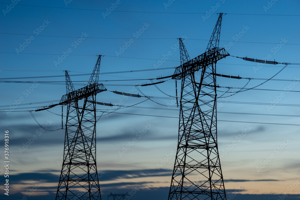 high voltage pylons against the background of the evening sky