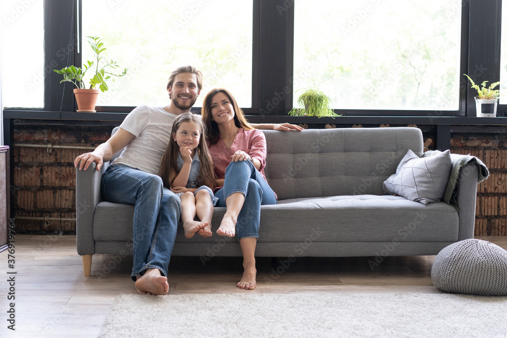 Cheerful family at home sitting in sofa Cheerful family at home sitting in sofa