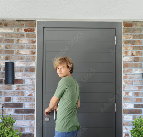 Man opening the door of her home.Inviting the guests.