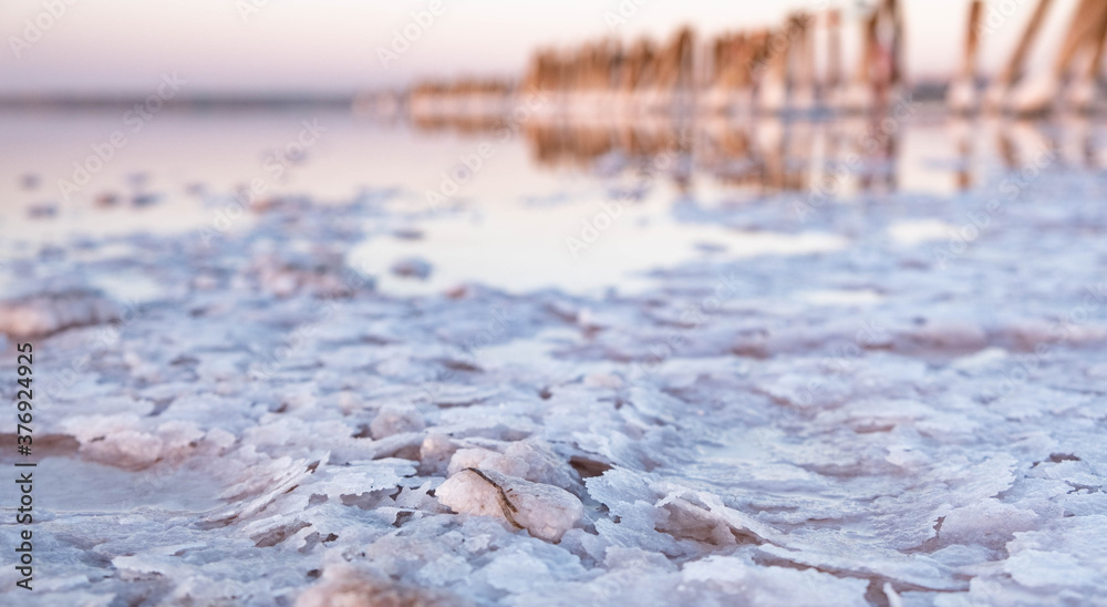 Unique salt lake Kuyalnik in Ukraine. Wooden poles reflected on the surface with the salt crystals. Unique salt lake Kuyalnik in Ukraine. Wooden poles reflected on the surface with the salt crystals.