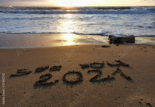 New Year 2021 is coming, message see you 2021 on a beach sand, Summer beach holiday 2020 season is over, copy space