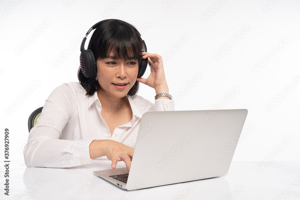Office woman wearing headphones for online meeting on laptop Office woman wearing headphones for online meeting on laptop