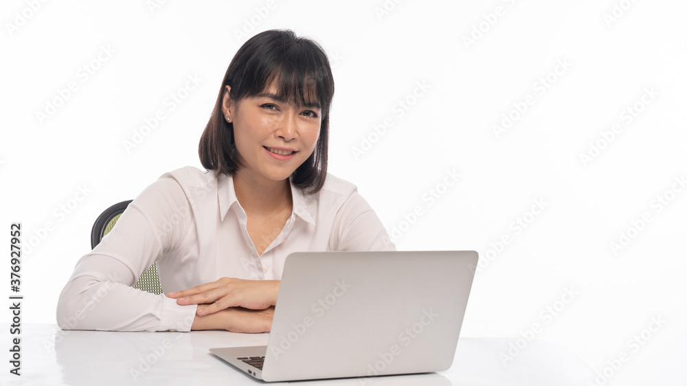 An office lady showing a happy expression on her desk has a labtob An office lady showing a happy expression on her desk has a labtob